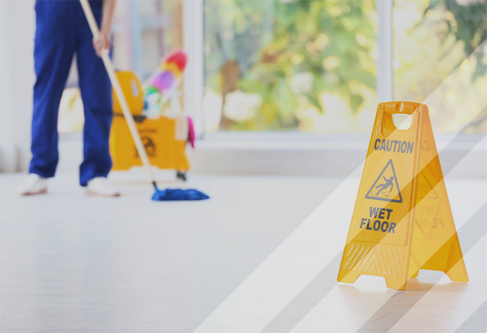 Person in blue clothes sweeping the floor